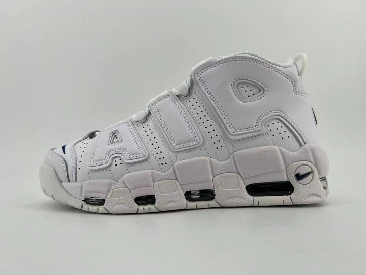 Side view of white Nike Air More Uptempo sneakers with oversized side lettering and a chunky sole