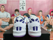 Rear view showing white heels with purple vertical panel details and contrasting outsole edges.