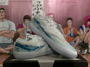 Angled view of the pair highlighting the blue side detailing, white overlays, and rubber soles.