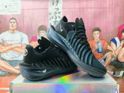 Angled view of paired black Nike GT basketball sneakers showing the layered upper, lace system, side details, and soles.
