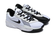 White and black Nike Academy sneakers shown together from an elevated three-quarter angle.