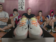 Front view of the pair showing white toe boxes, white laces, orange tongue accents, and black Swoosh details.