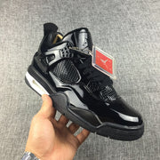 Angled side view of a black sneaker showing the mesh panel, side support, hangtag, and light-colored midsole section.