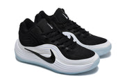 Angled view of the black and white Nike sneaker pair showing the laces, layered side panels, and outsoles.