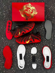 Disassembled sneaker components including red and gray insoles, outsole sections and white cushioning pieces.