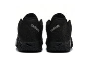 Rear view of the pair showing embroidered TWELVE heel branding and textured black soles.