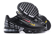 Side and outsole views of black Nike Air Max Plus sneakers with multicolor accents and visible cushioning.