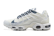 Side profile of a white sneaker with navy accents and visible sole cushioning
