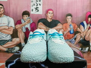 Front view of pale blue and white Nike basketball shoes with bright blue laces.