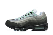Side profile of a Nike Air Max 95 TT sneaker with layered grey panels, black accents and mint-green details.