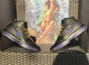 Two high-top sneakers posed upright, showing the purple side accents and contrasting yellow laces.