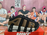 Side profile highlighting the brown and black layered upper, structured overlays, and contrasting sole.