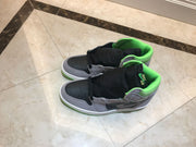 Top view of the pair showing black perforated toe boxes, grey overlays and green collars.