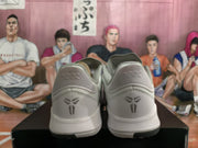 Rear view of the sneakers showing Kobe-style heel logos, padded collars, and white-gray construction.