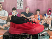Side view of a red and black Adidas basketball sneaker showing the lace-up construction, padded black collar and layered side detailing.