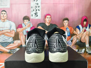 Rear view of the shoes with patterned black heel panels and large graphic detailing