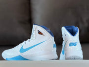 Rear and side view showing the blue collar lining, heel branding, and white high-top construction.