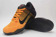 Nike Kobe 11 shoes viewed from the front and underside, showing orange laces and black outsole