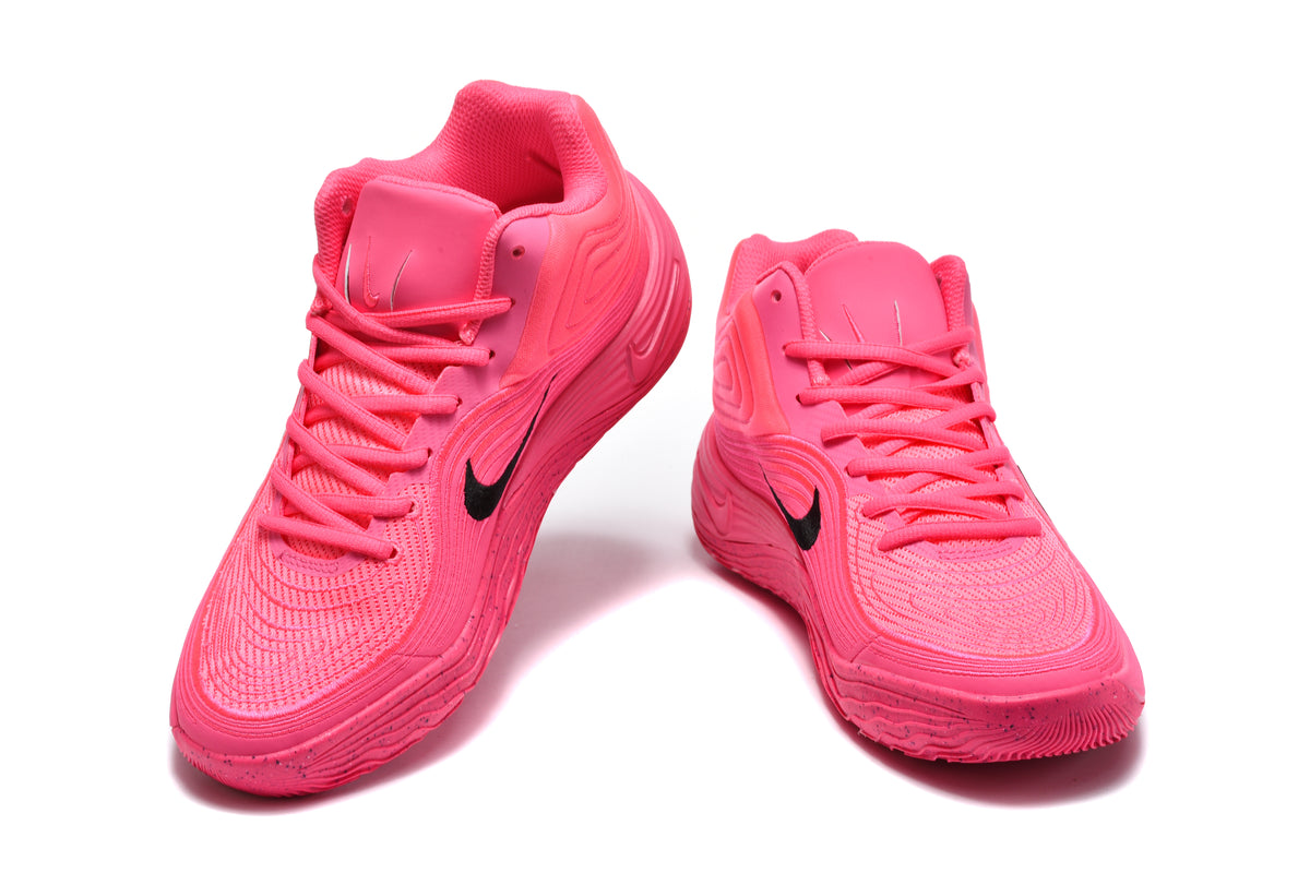 Pair of bright pink Nike basketball sneakers shown from the front and side with black Swoosh branding.