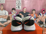 Heel view showing black heel panels, red Swooshes, and speckled midsoles