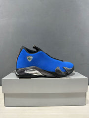 Side profile of a blue and black Jordan Air Jordan 14 Retro sneaker displayed on a box.