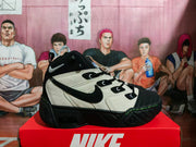 Side profile of a black and cream Nike high-top sneaker with a large Swoosh and green sole stitching.
