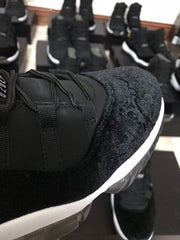 Close-up of the black textured toe area, laces, and contrasting white midsole.