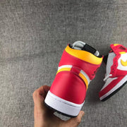 Close rear view showing the red heel, yellow collar and layered side panels.