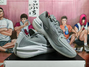 Angled view of gray Nike basketball shoes showing the mesh-patterned sides and sculpted soles