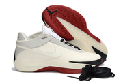 Side view of an off-white Jordan 40 sneaker beside its patterned red outsole.