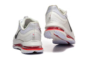 Rear and outsole views of white Nike Pegasus Premium shoes with red cushioning.