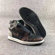 Pair of Jordan Air Jordan 1 high-top sneakers showing the black, gray, and bronze-toned upper and outsole.
