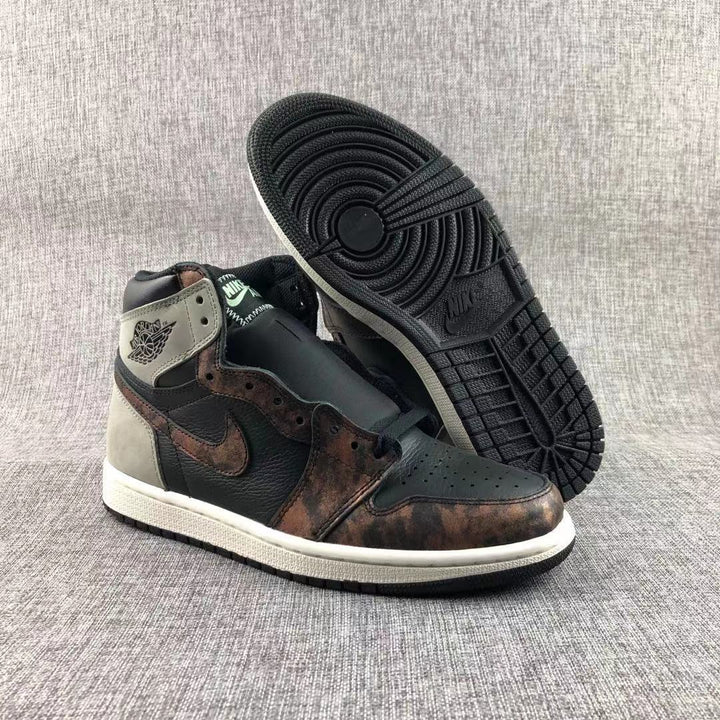 Pair of Jordan Air Jordan 1 high-top sneakers showing the black, gray, and bronze-toned upper and outsole.