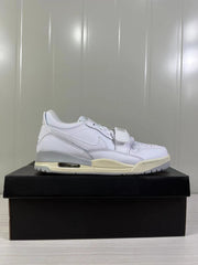 Opposite side profile of the white low-top sneaker with a perforated toe and textured outsole.