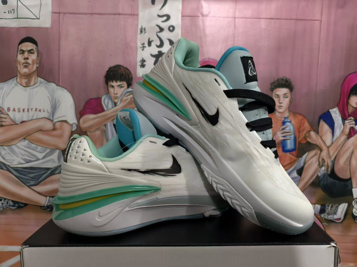 Pair of white Nike basketball sneakers with black Swoosh branding and turquoise-green accents, shown at an angle.