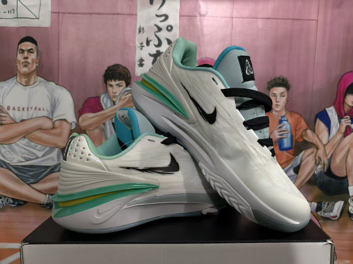 Pair of white Nike basketball sneakers with black Swoosh branding and turquoise-green accents, shown at an angle.
