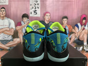 Rear view showing the black heel sections, patterned blue and green panels and bright green collars.