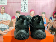 Rear view of black Nike basketball shoes showing heel detailing and outsole tread.