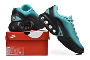 Nike Air Max DN sneakers beside a box; the box label shows US sizes 8.5 and 10 for the photographed sample.