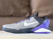 Side profile of gray, black, purple, and white Kobe 7 basketball shoes.