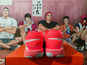 Rear view showing the red mesh-like heel panels, white accent strip, and textured outsole sections.