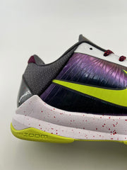 Close-up of the purple side panel, volt Swoosh, dark heel textile, and speckled midsole.