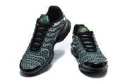 Front views of a pair of green, black, and silver Nike Air Max Plus sneakers.