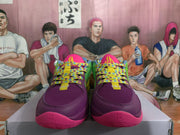 Front view of multicolor Nike basketball shoes with purple toes, patterned laces, and bright pink accents