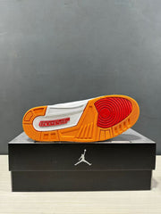 Outsole view showing the orange rubber tread, red circular forefoot traction area and Jordan branding.