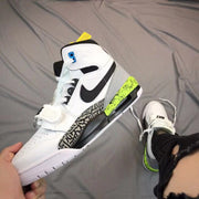 Side view of the high-top sneaker with black and green accents
