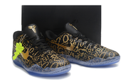 Black and gold patterned Kobe 11 pair displayed against a dark background