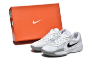 White and grey Nike GT Cut Academy basketball shoes beside an orange Nike shoe box.