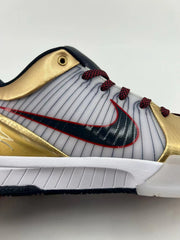 Close-up of the side logo, striped panel, gold overlays, and white midsole.