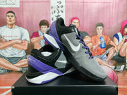 Angled view of the basketball sneakers highlighting the purple heel section and white midsole accents.